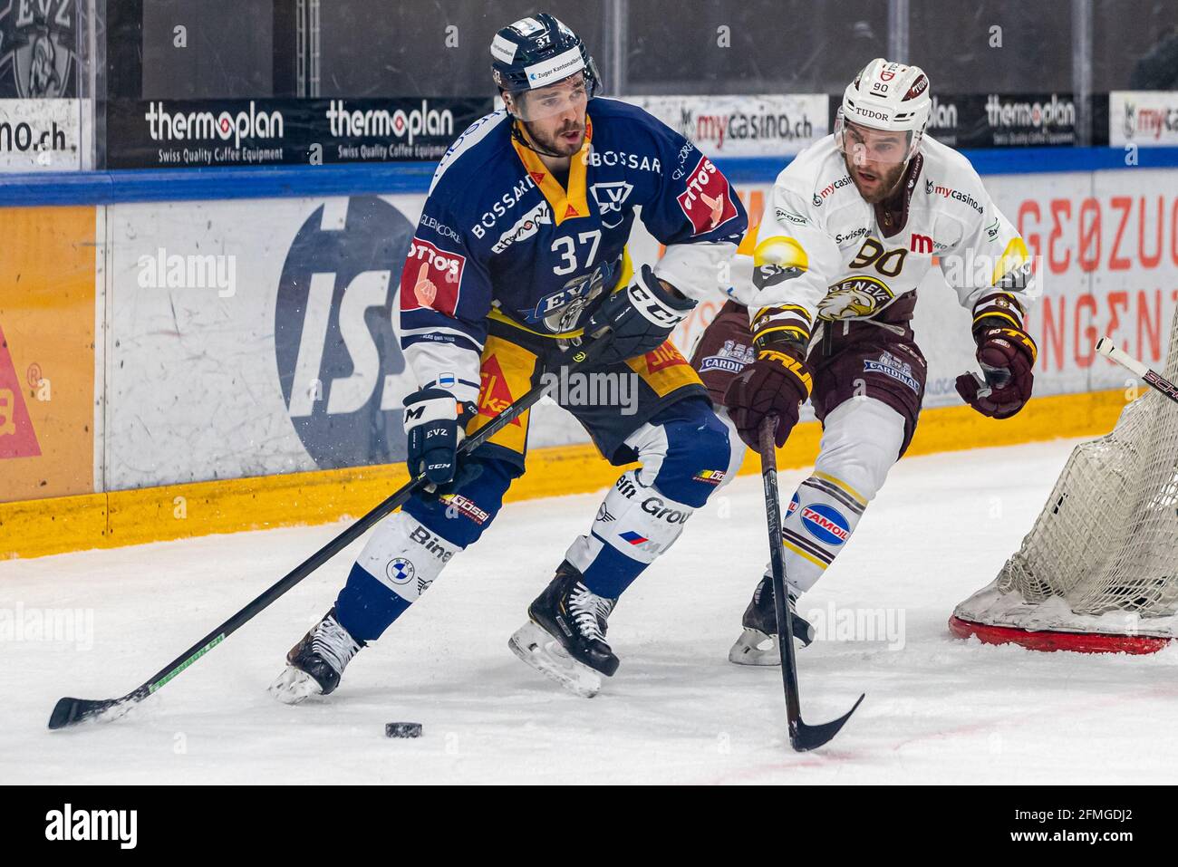 # 90 Simon Le Coultre (Geneva) follows Nick Shore # 37 (EV Zug) during the National League Playoff Final ice hockey game 3 between EV Zug and Geneve-Servette HC on May 7th, 2021 in the Bossard Arena in Zug. (Switzerland/Croatia OUT) Credit: SPP Sport Press Photo. /Alamy Live News Stock Photo