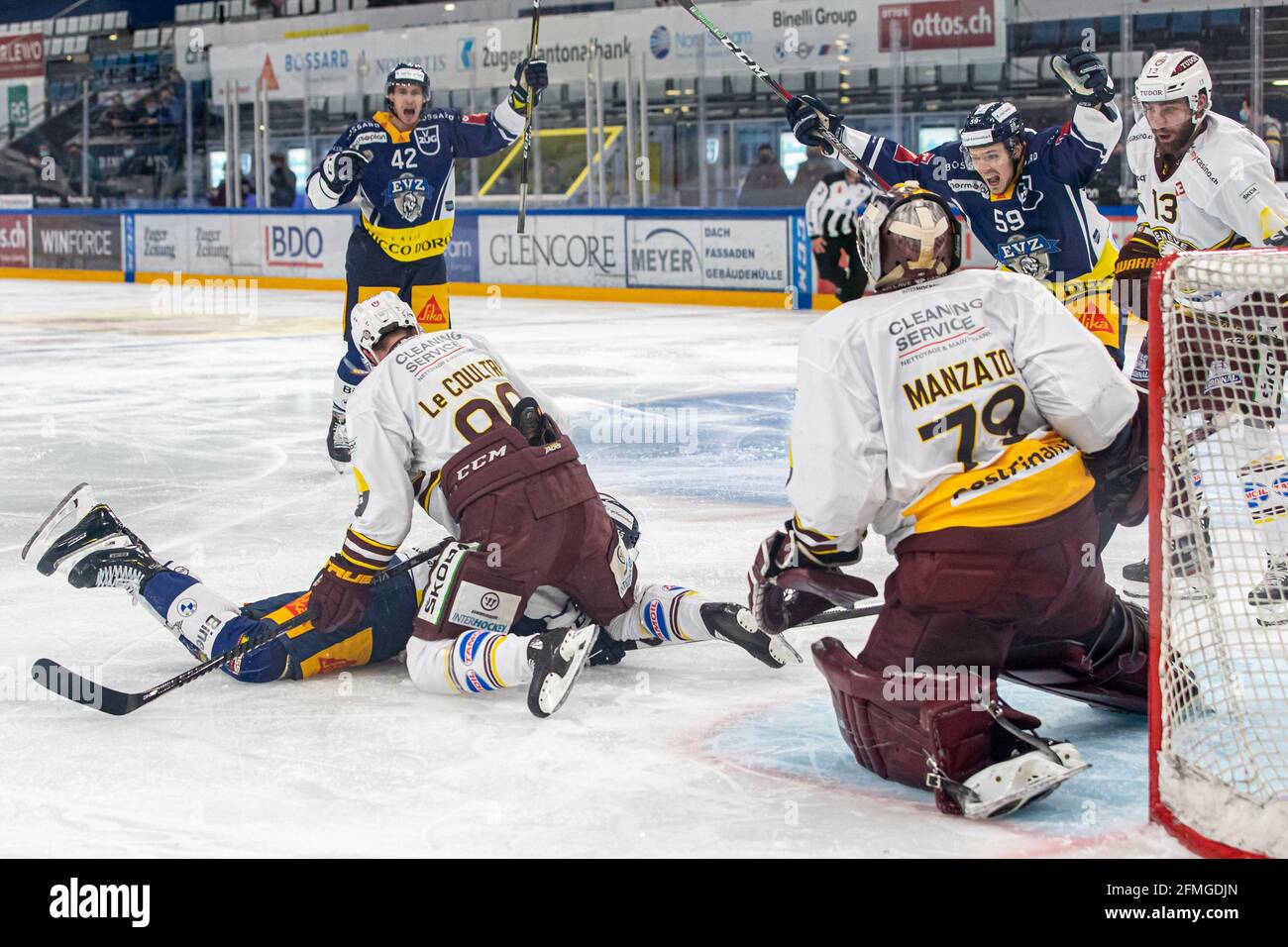 Goalscorer Gregory Hofmann # 15 (EV Zug) is buried after scoring # 90 Simon Le Coultre (Geneva), while Tobias Geisser # 42 (EV Zug) and Justin Abdelkader # 89 (EV Zug) are already cheering during the National League Playoff Final Ice hockey game 3 between EV Zug and Geneve-Servette HC on May 7th, 2021 in the Bossard Arena in Zug. (Switzerland/Croatia OUT) Credit: SPP Sport Press Photo. /Alamy Live News Stock Photo