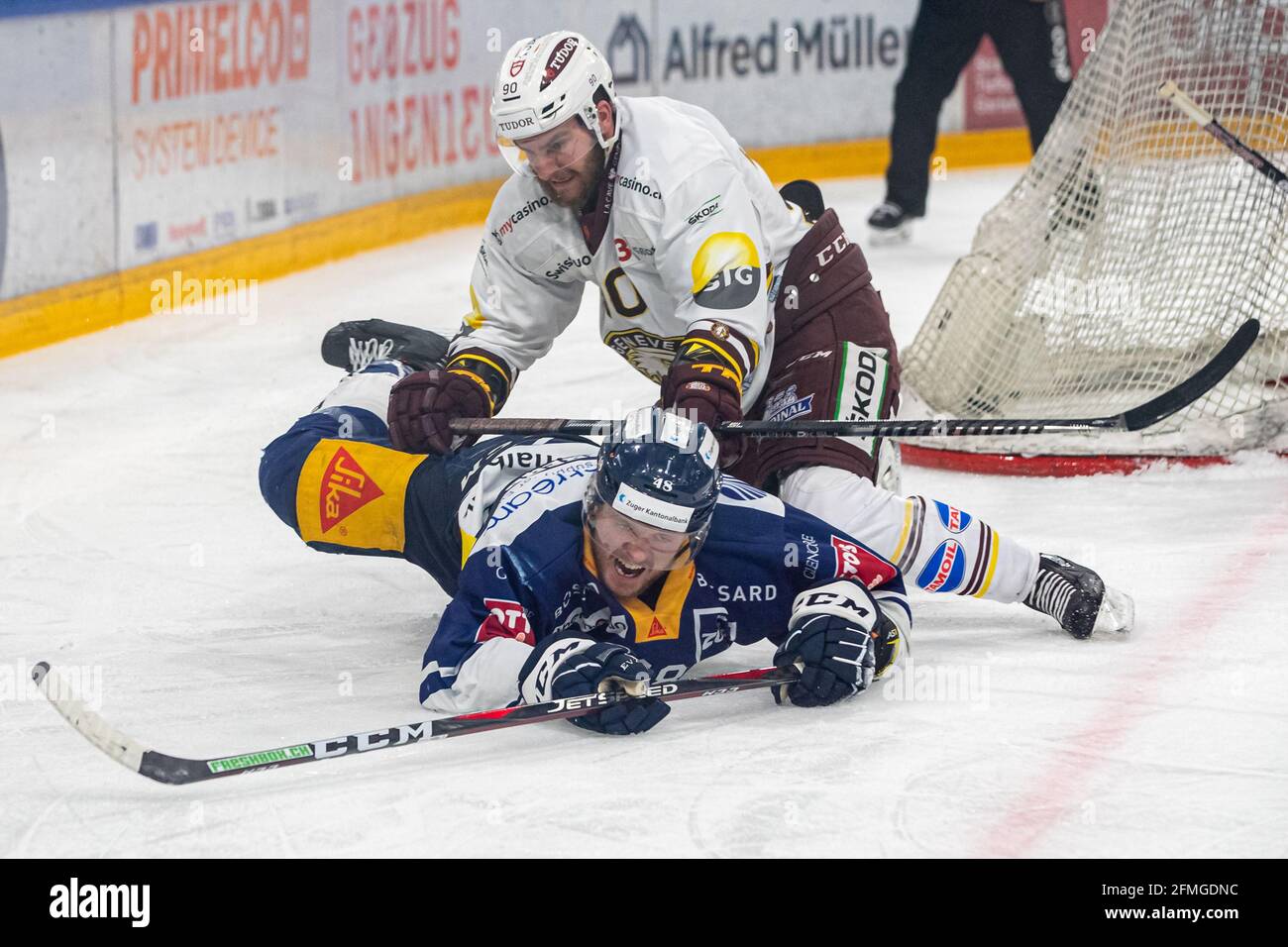 # 90 Simon Le Coultre (Geneva) works on Carl Klingberg # 48 (EV Zug) during the National League Playoff Final ice hockey game 3 between EV Zug and Geneve-Servette HC on May 7th, 2021 in the Bossard Arena in Zug. (Switzerland/Croatia OUT) Credit: SPP Sport Press Photo. /Alamy Live News Stock Photo