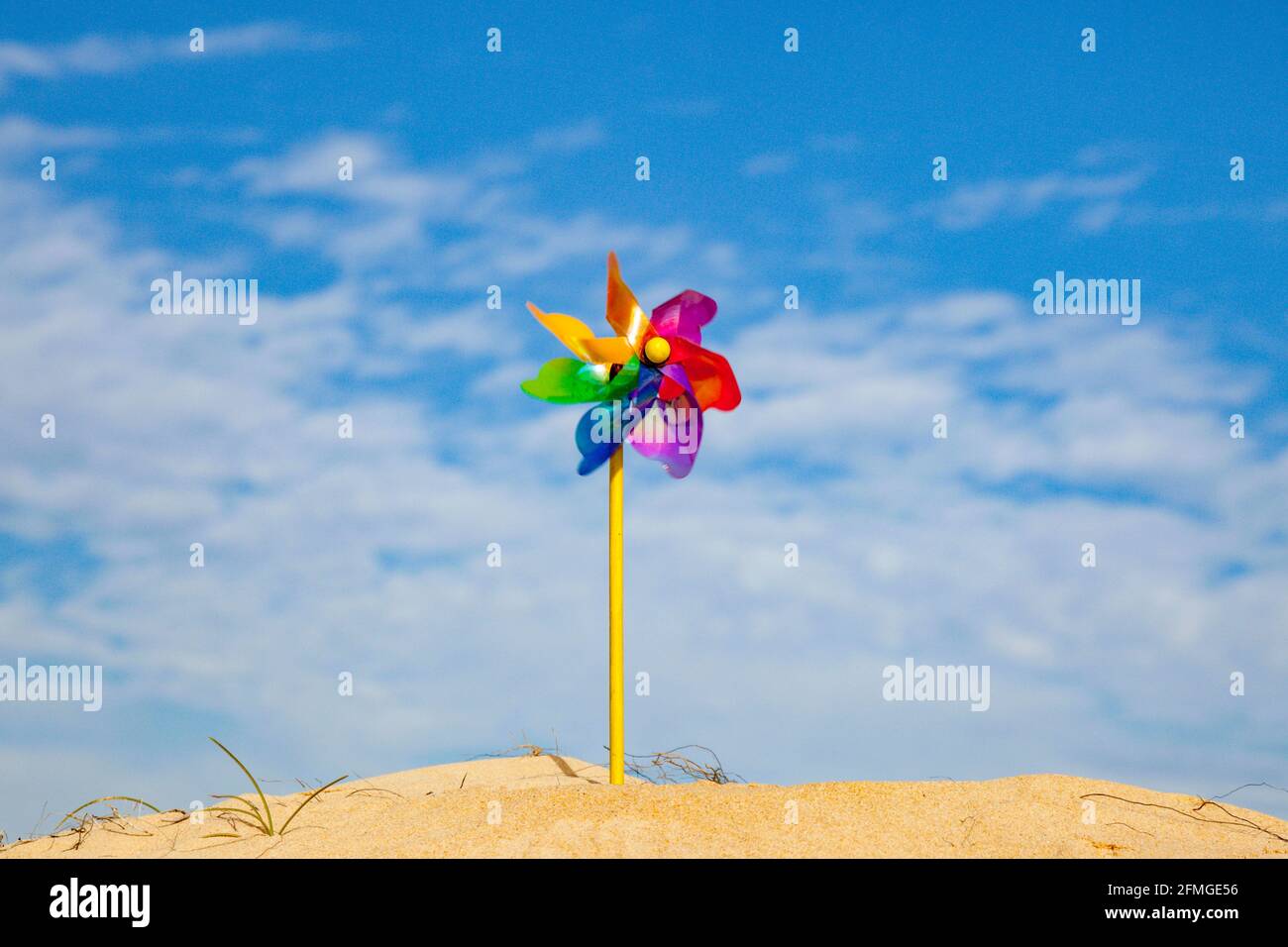 Children's wind propeller spinner on the background of the sky Stock Photo