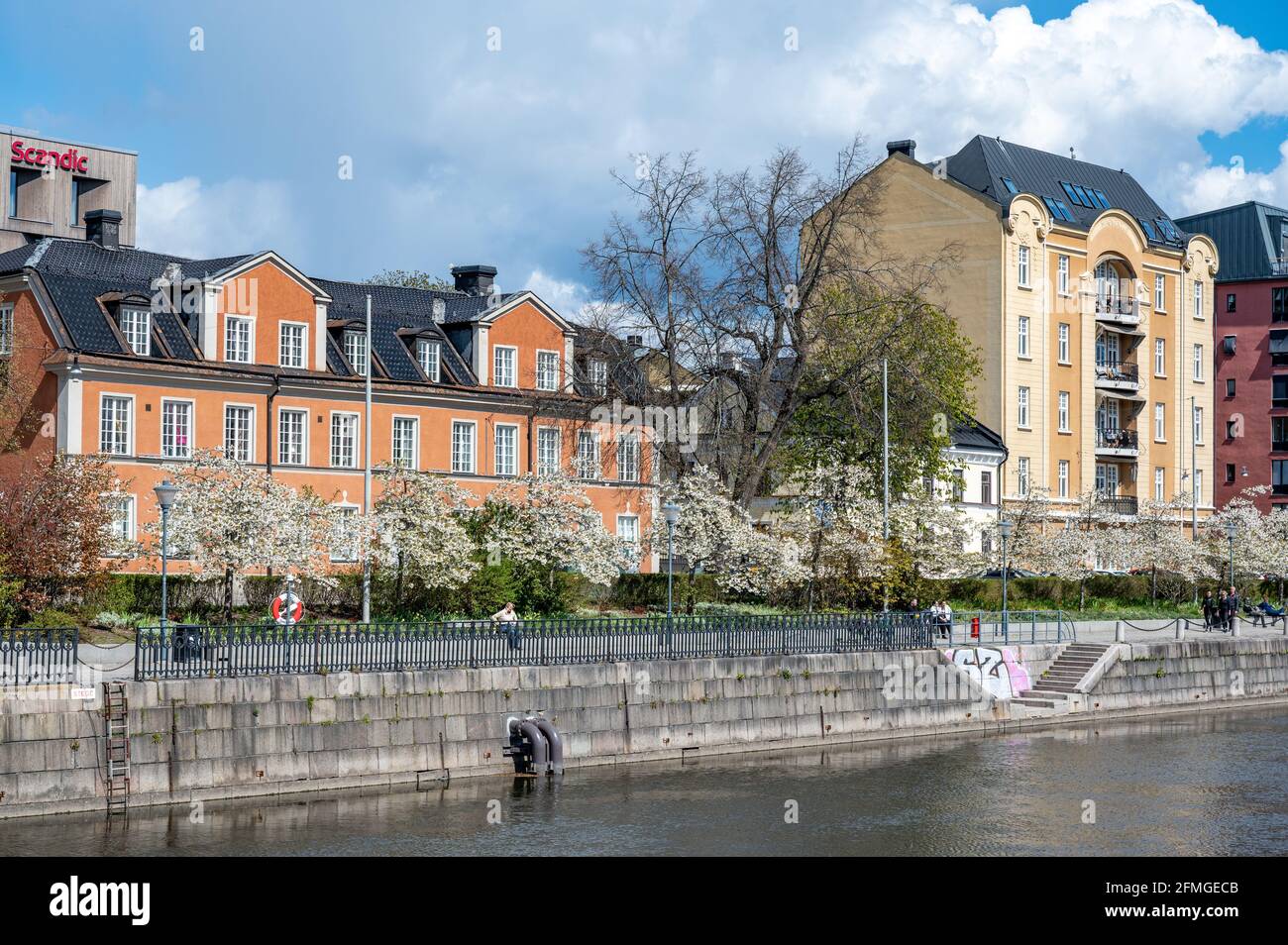 Historic W6-House (left) at Norrköping waterfront Saltängen and Motala stream on a spring day in early May 2021. Stock Photo