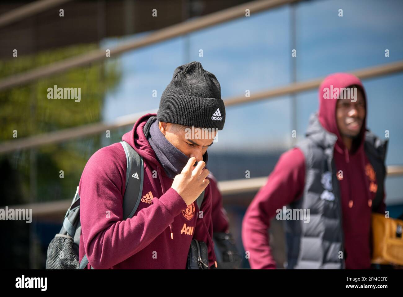 Birmingham, UK. May 9th 2021: Close-up of Marcus Rashford with Pogba in the background, adjusting his face covering as he heads out a hotel for a match against Aston Villa in Birmingham. Credit: Ryan Underwood/Alamy Live News Stock Photo