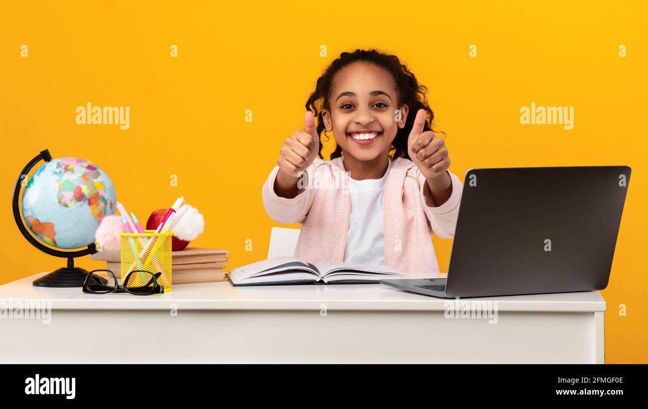 Portrait of smiling black girl student showing thumbs up Stock Photo ...