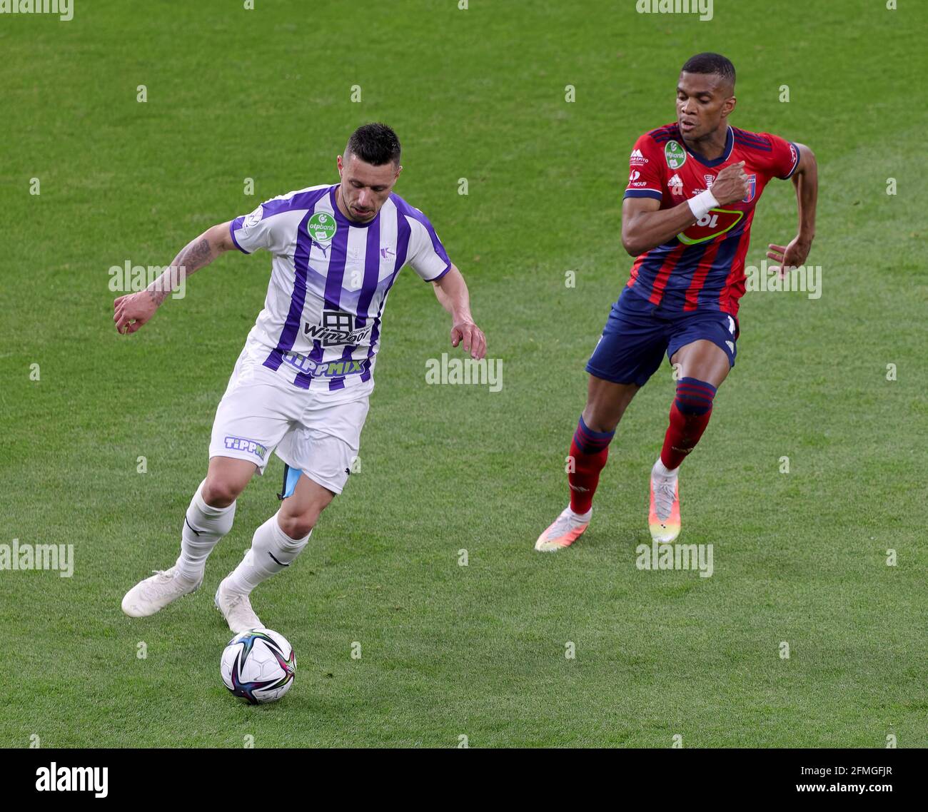 Branko Pauljevic of Ujpest FC competes for the ball with Tokmac