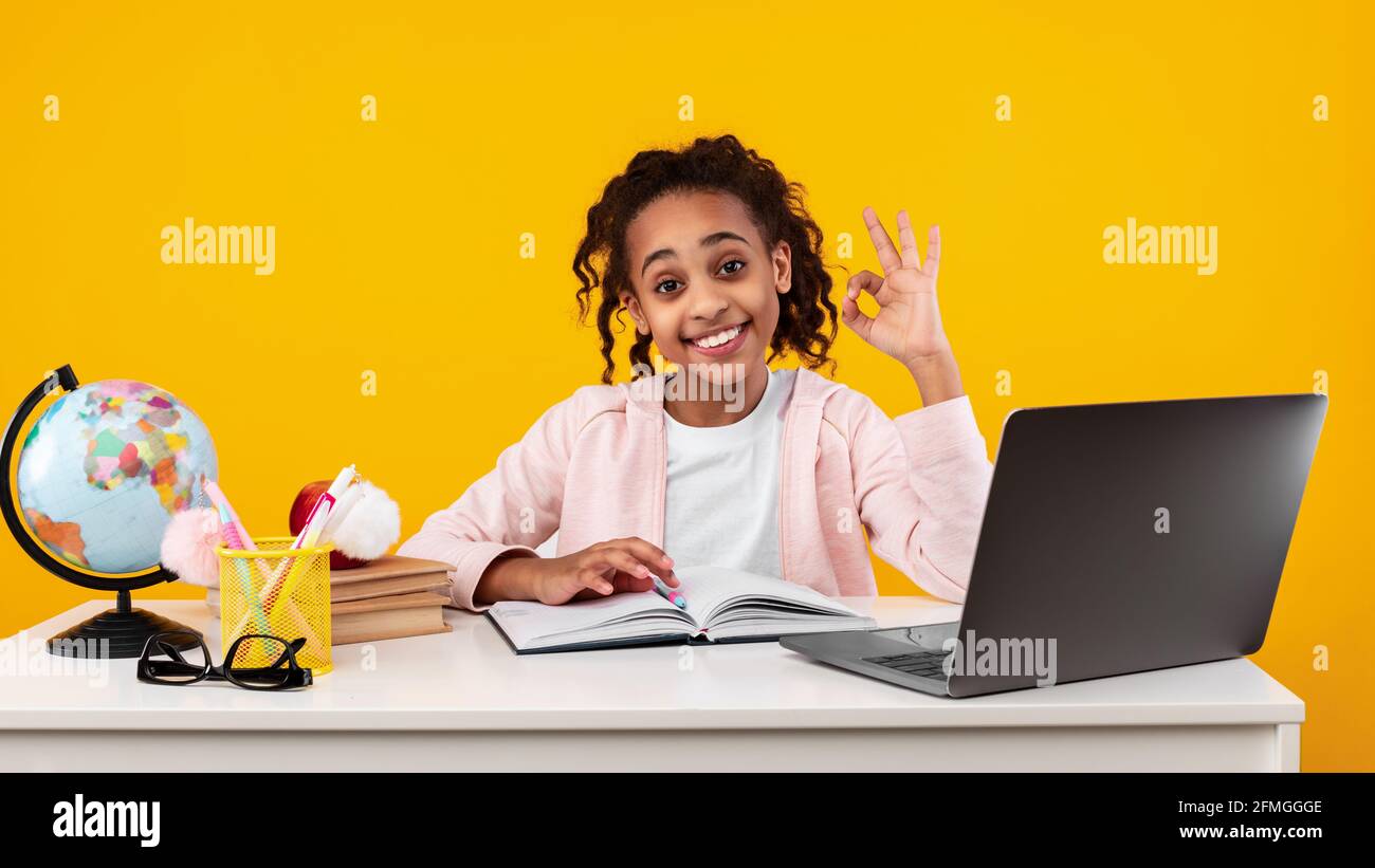 Portrait of smiling black girl student showing okay gesture Stock Photo ...