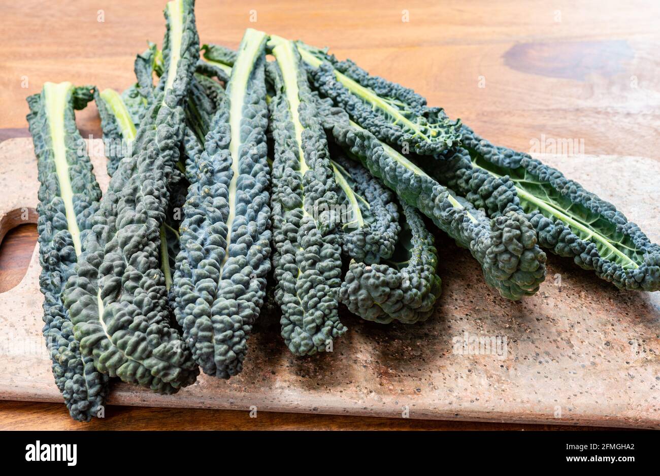 Vegetarian Cooking With Black Flat Leaves Of Cavolo Nero Tuscan Cabbage vegetarian-cooking-with-black-flat-leaves-of-cavolo-nero-tuscan-cabbage