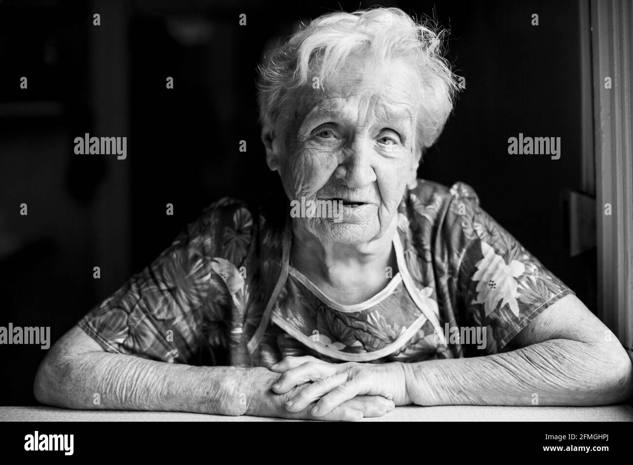 Portrait of old woman in her home. Black-and-white photo Stock Photo ...