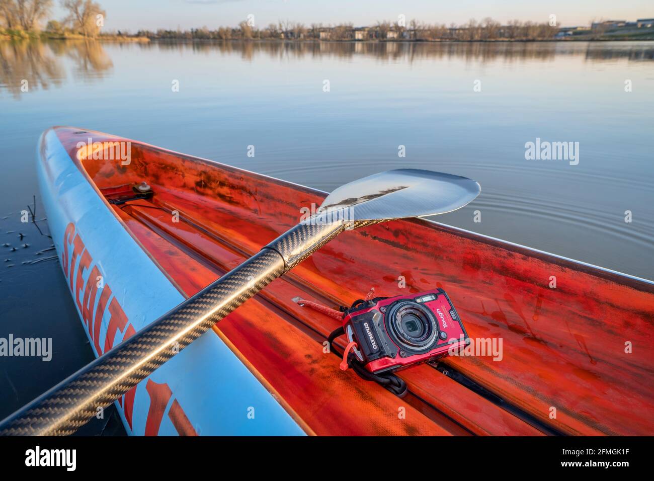 Fort Collins, CO, USA - May 6, 2021: Compact, waterproof Olympus Stylus Tough TG-5 camera on a rear deck of a stand up paddleboard by Mistral, early s Stock Photo