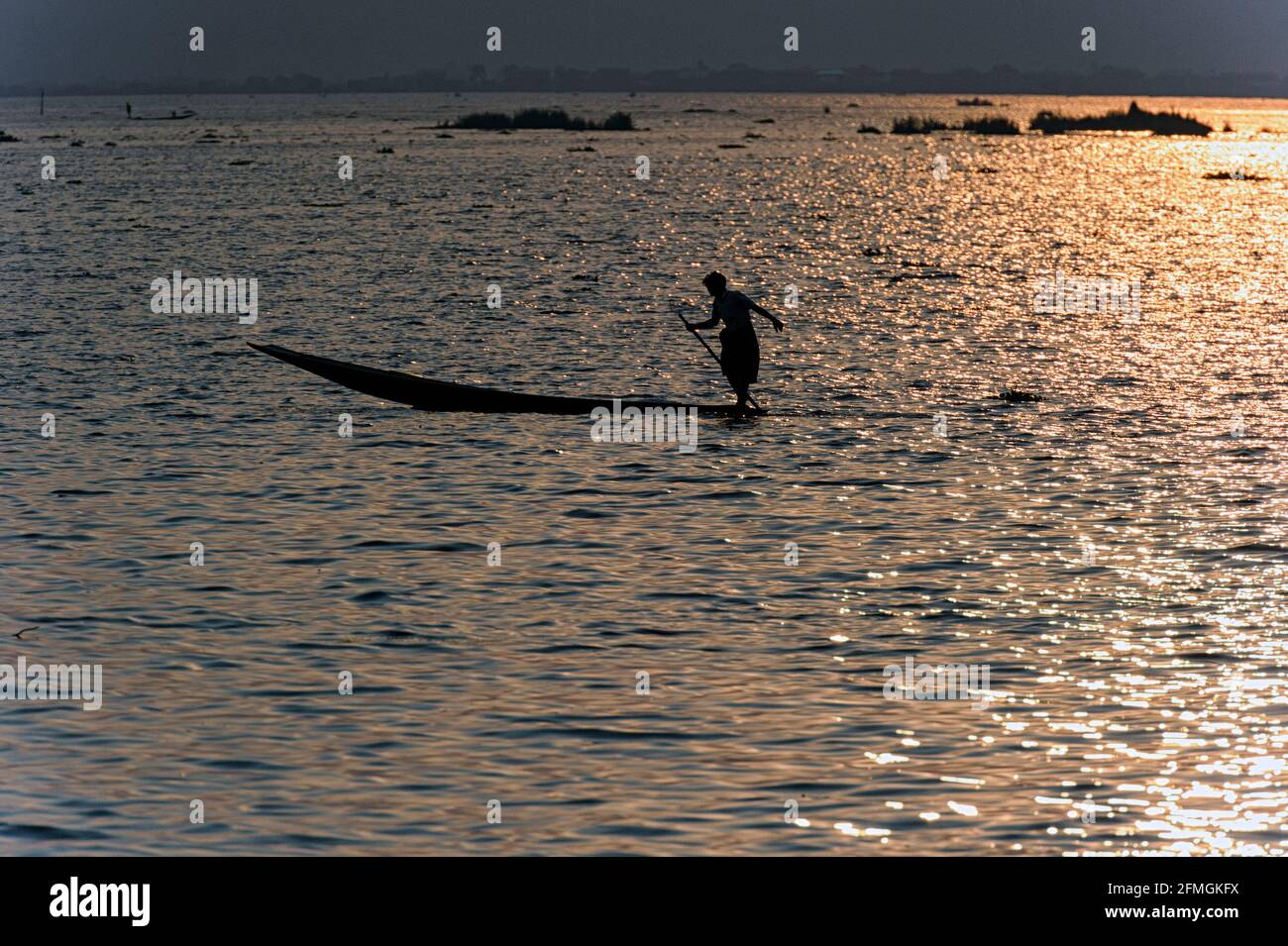 Man fishing on Inle Lake, Myanmar Burma at sunset Stock Photo