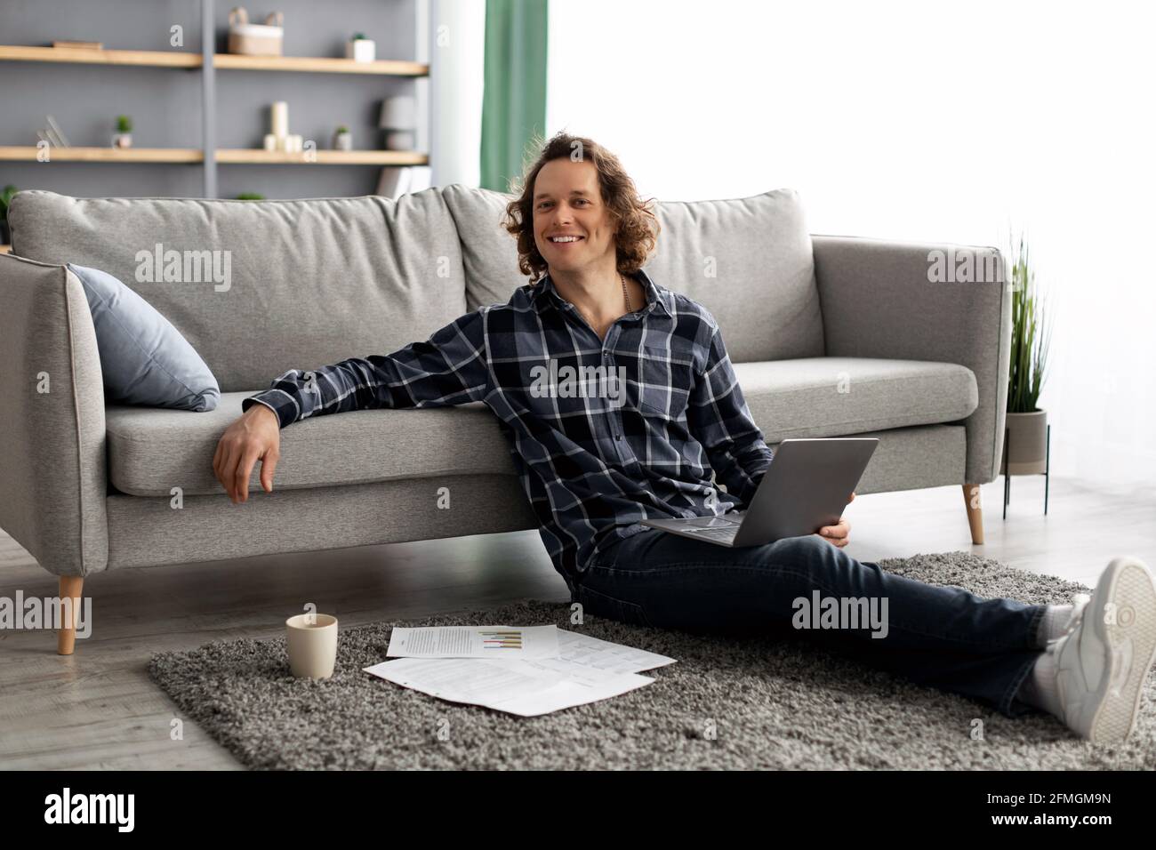 Successful Freelancer Man Posing With Laptop Working Online From Home Stock Photo