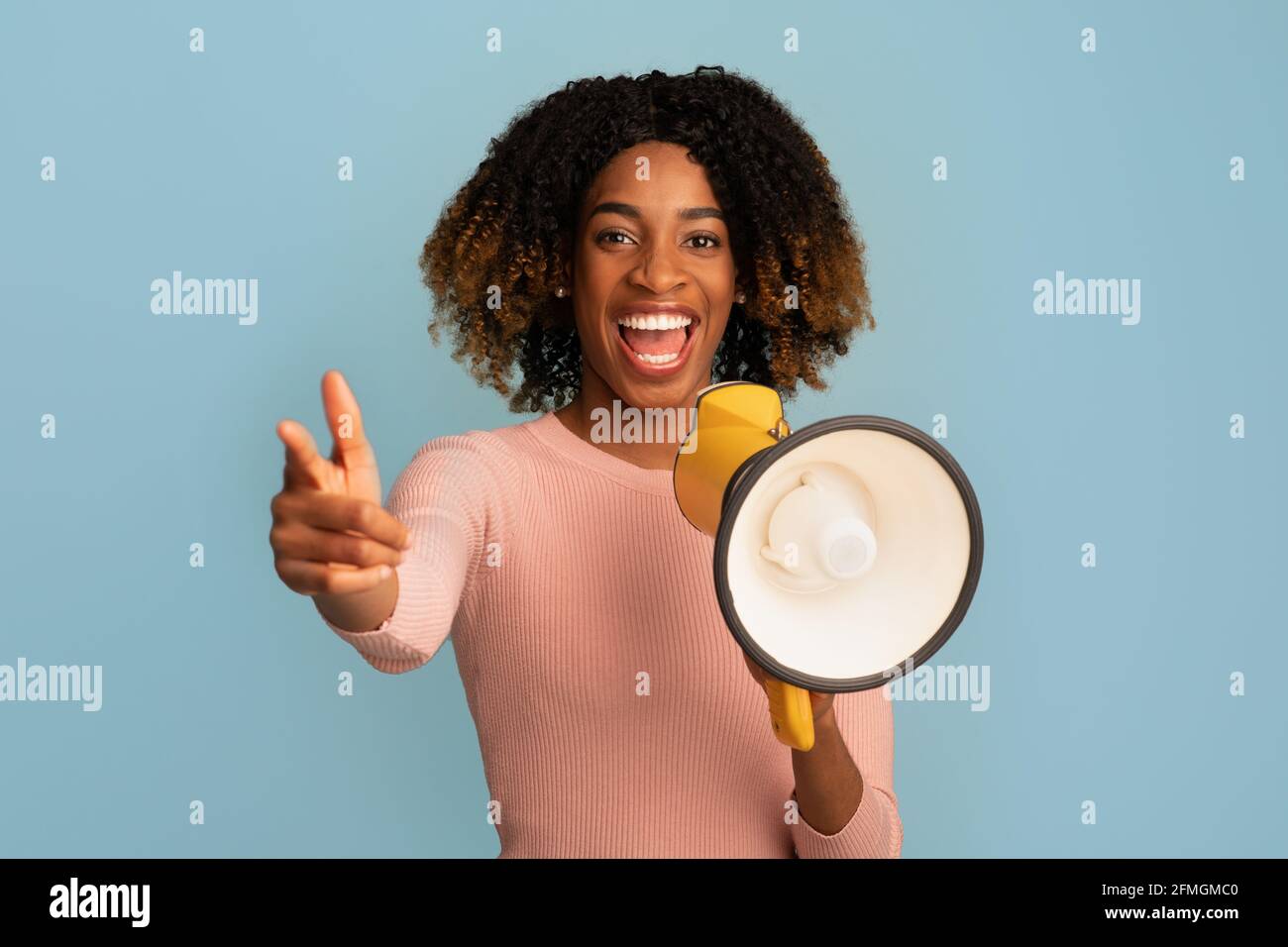 Emotional Cheerful Black Woman Making Announcement With Megaphone In Hands Stock Photo