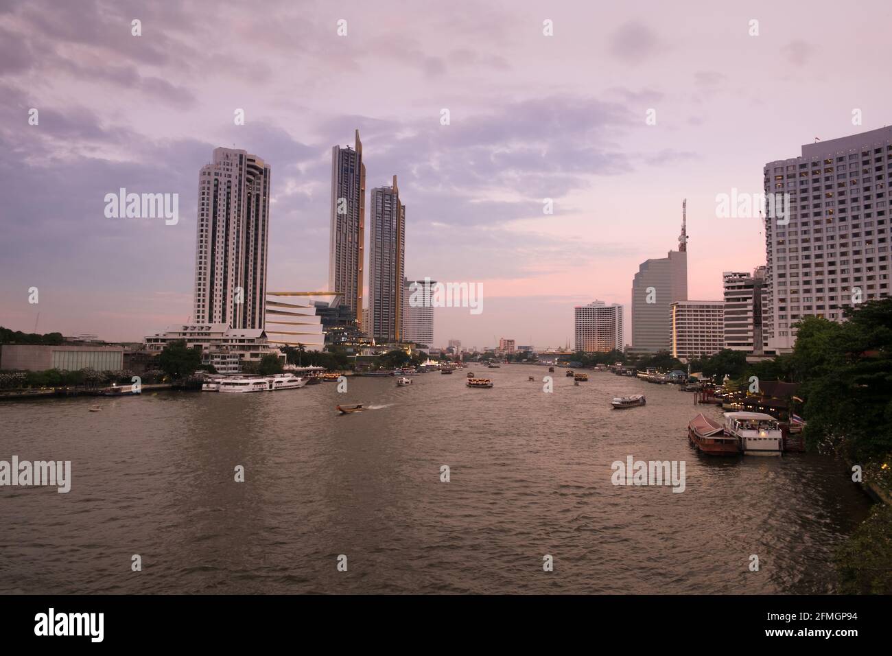 Landscape view of sunset at Chao Phraya river with a view of boats and ...