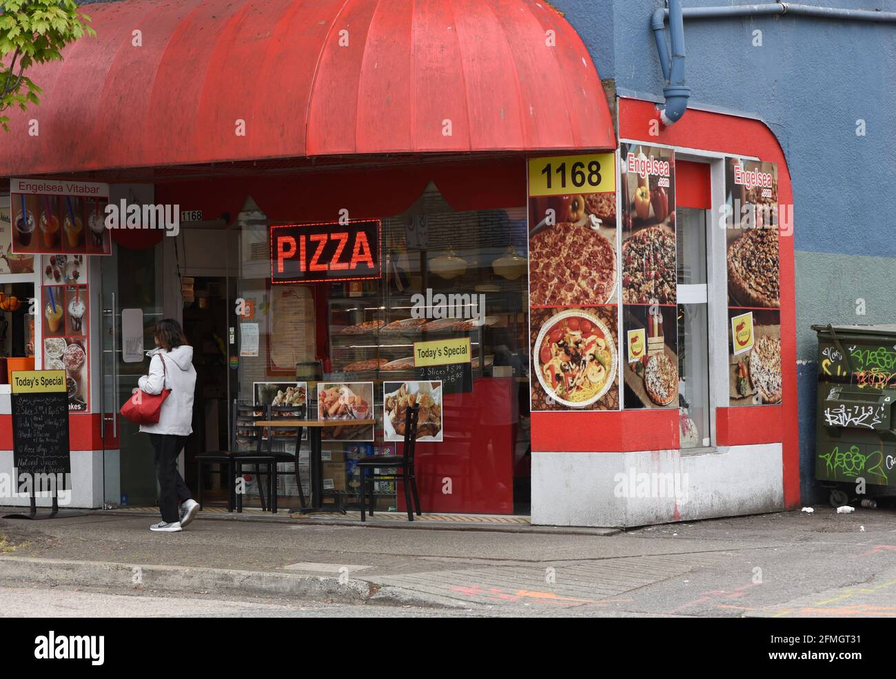 A small restaurant advertises pizza for sale along Denman Street in the West End district in Vancouver, British Columbia, Canada Stock Photo