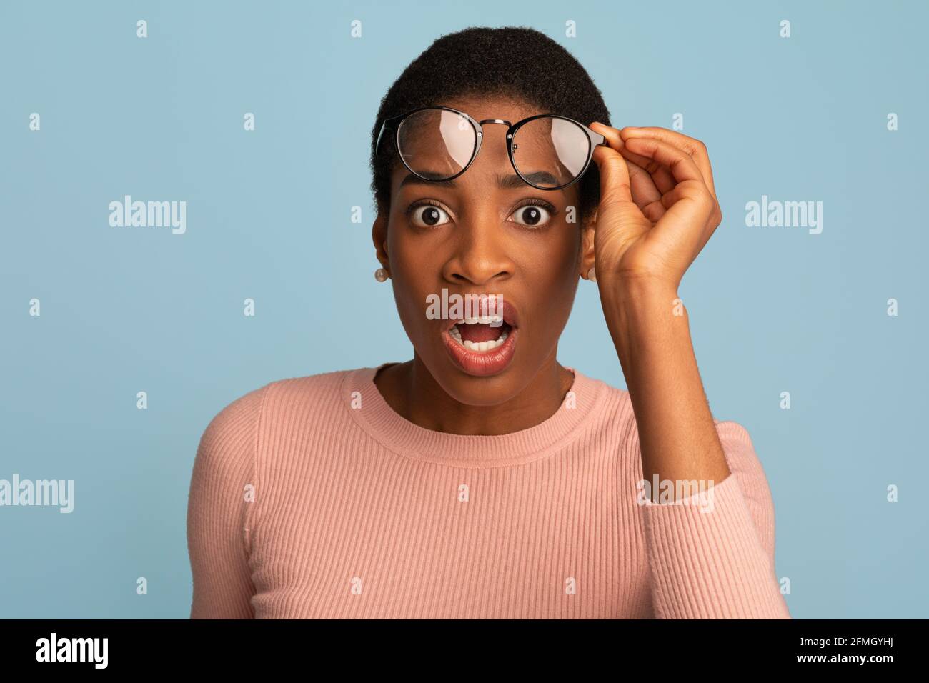 Confused Black Female Taking Off Glasses And Looking At Camera With Shock  Stock Photo - Alamy
