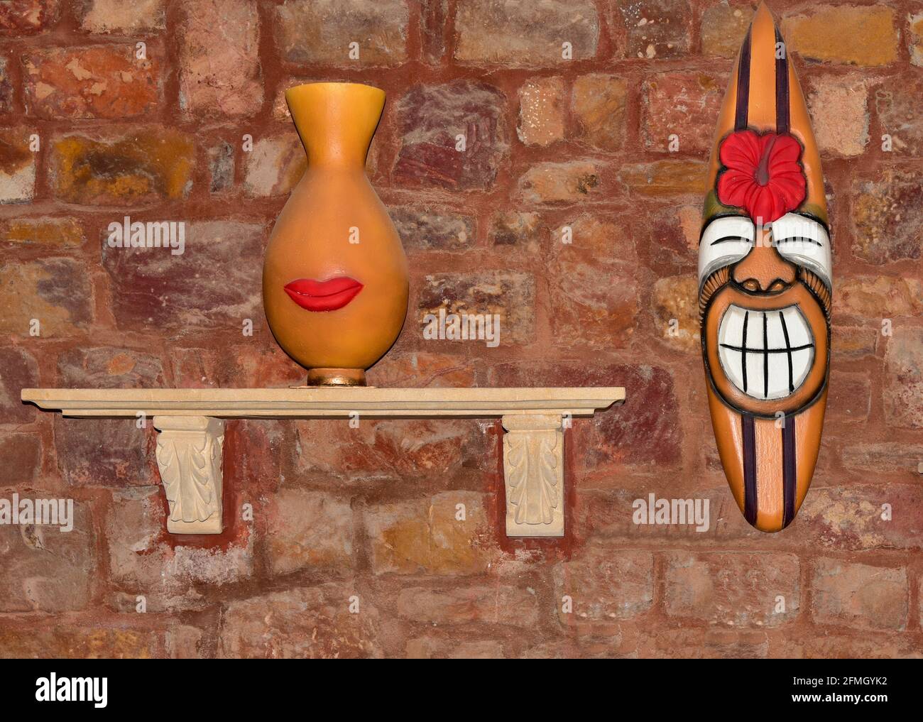 Funny African clay sculptures on the wall Stock Photo Alamy