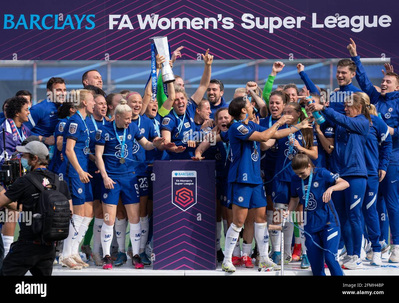Kingston, UK. 09th May, 2021. Magdalena Eriksson of Chelsea Women lifts the trophy as teammates celebrate after the team are crowned 2020/21 FAWSL champions during the FAWSL match between Chelsea Women and Reading Women at the Kingsmeadow Stadium, Kingston, England on 9 May 2021. Photo by Andy Rowland. Credit: PRiME Media Images/Alamy Live News Stock Photo