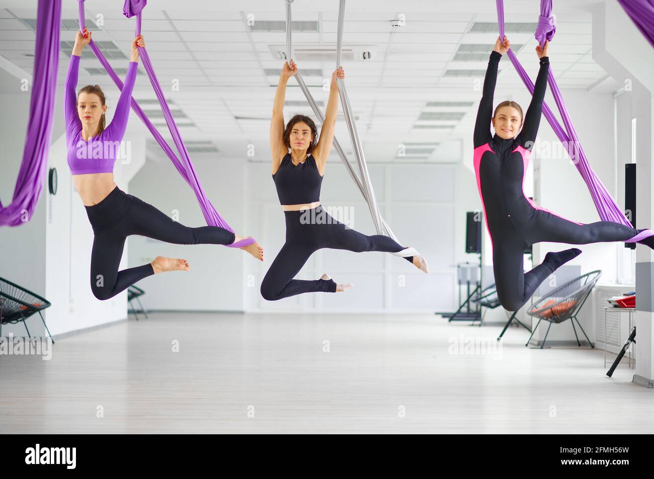 Aerial yoga studio, hanging on hammocks Stock Photo Alamy