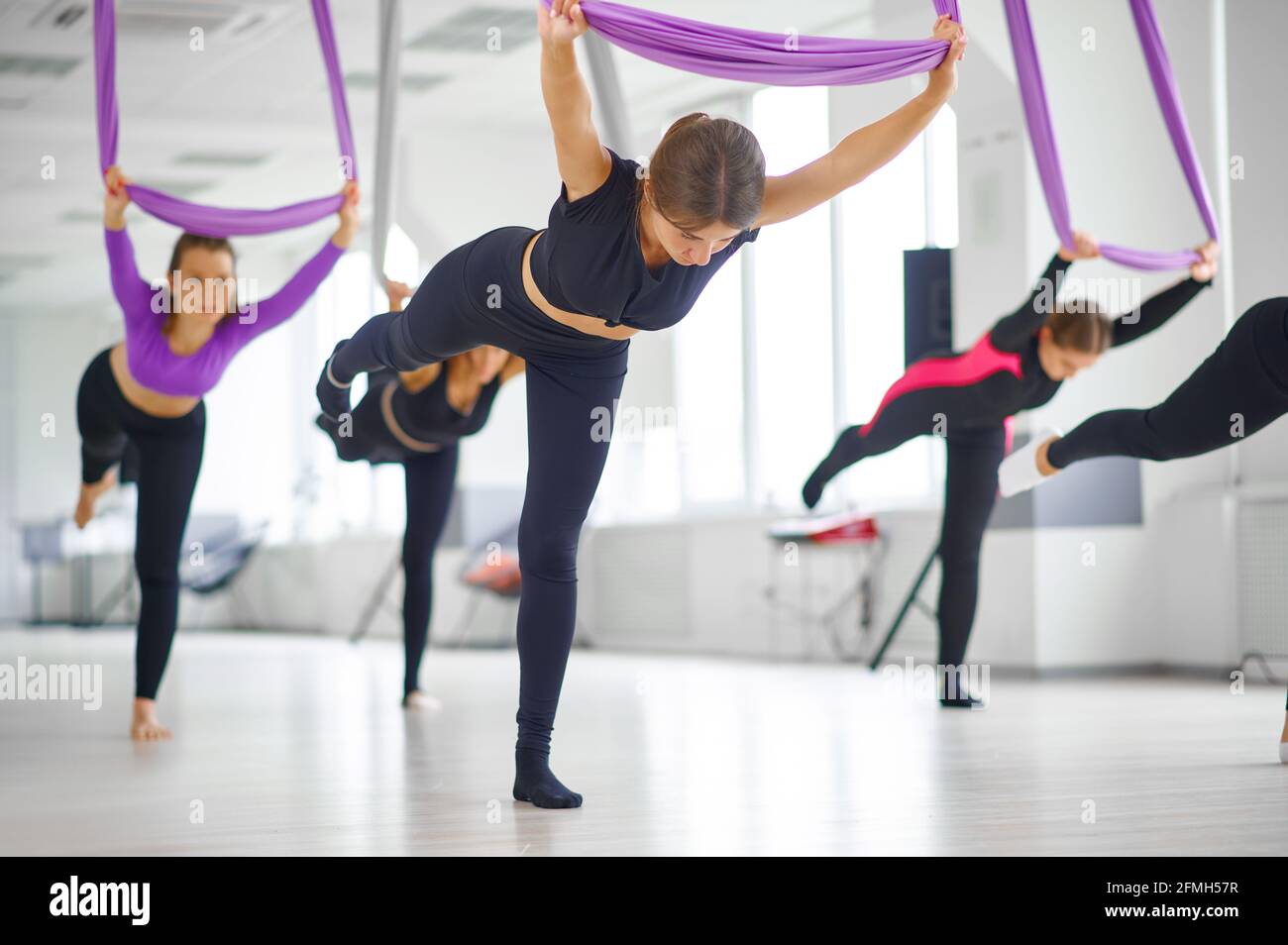 Aerial yoga studio, hanging on hammocks Stock Photo Alamy