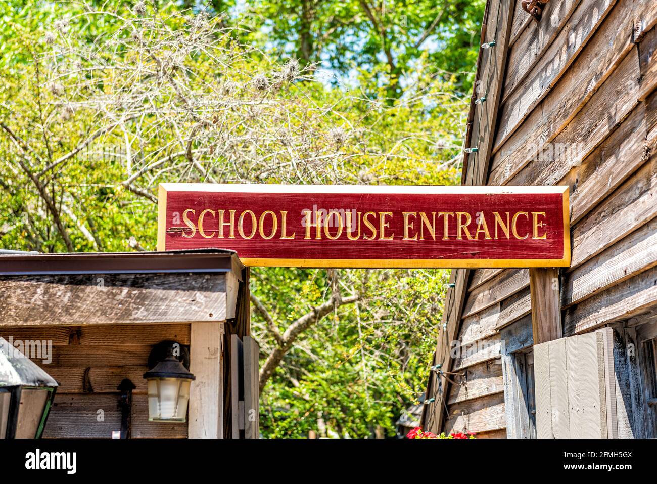 St. Augustine, Florida downtown old town city with oldest wood school house in Spanish colonial quarter in summer with red sign text entrance Stock Photo