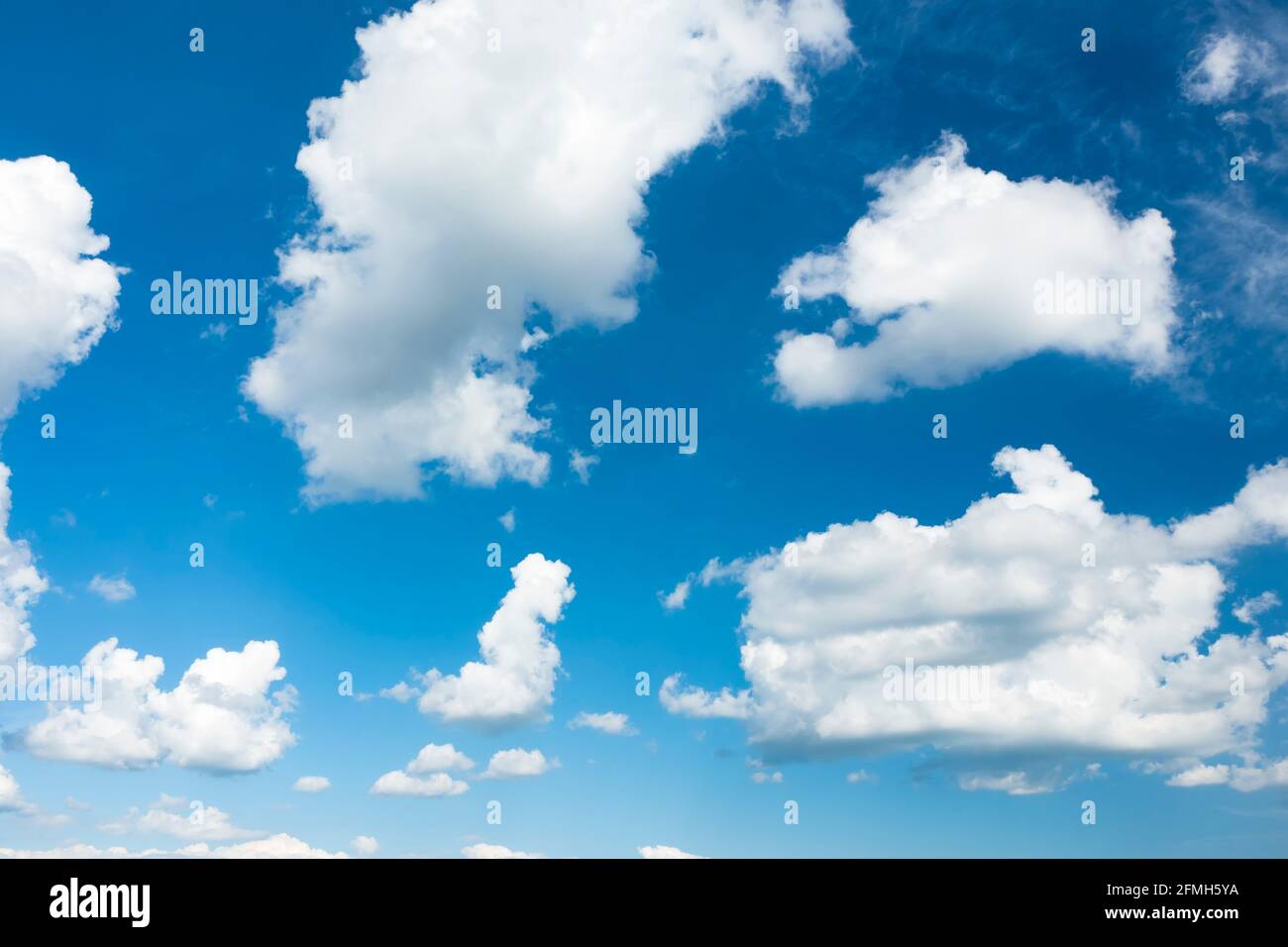 Stunning view of a blue sky with some fluffy clouds. Aerial shoot ...