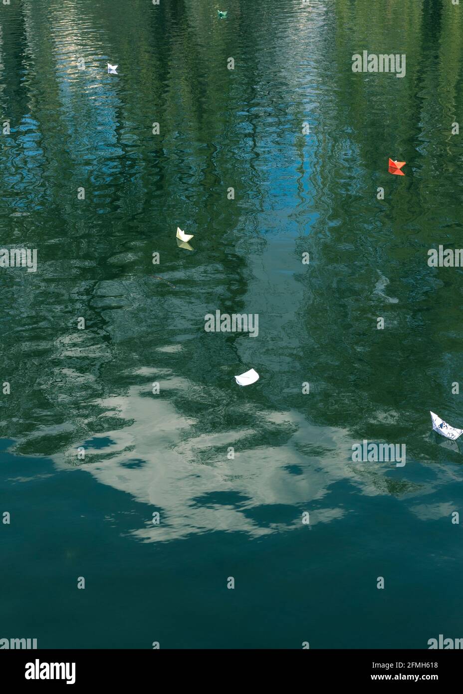 Many paper boats float on the water. Origami Stock Photo - Alamy