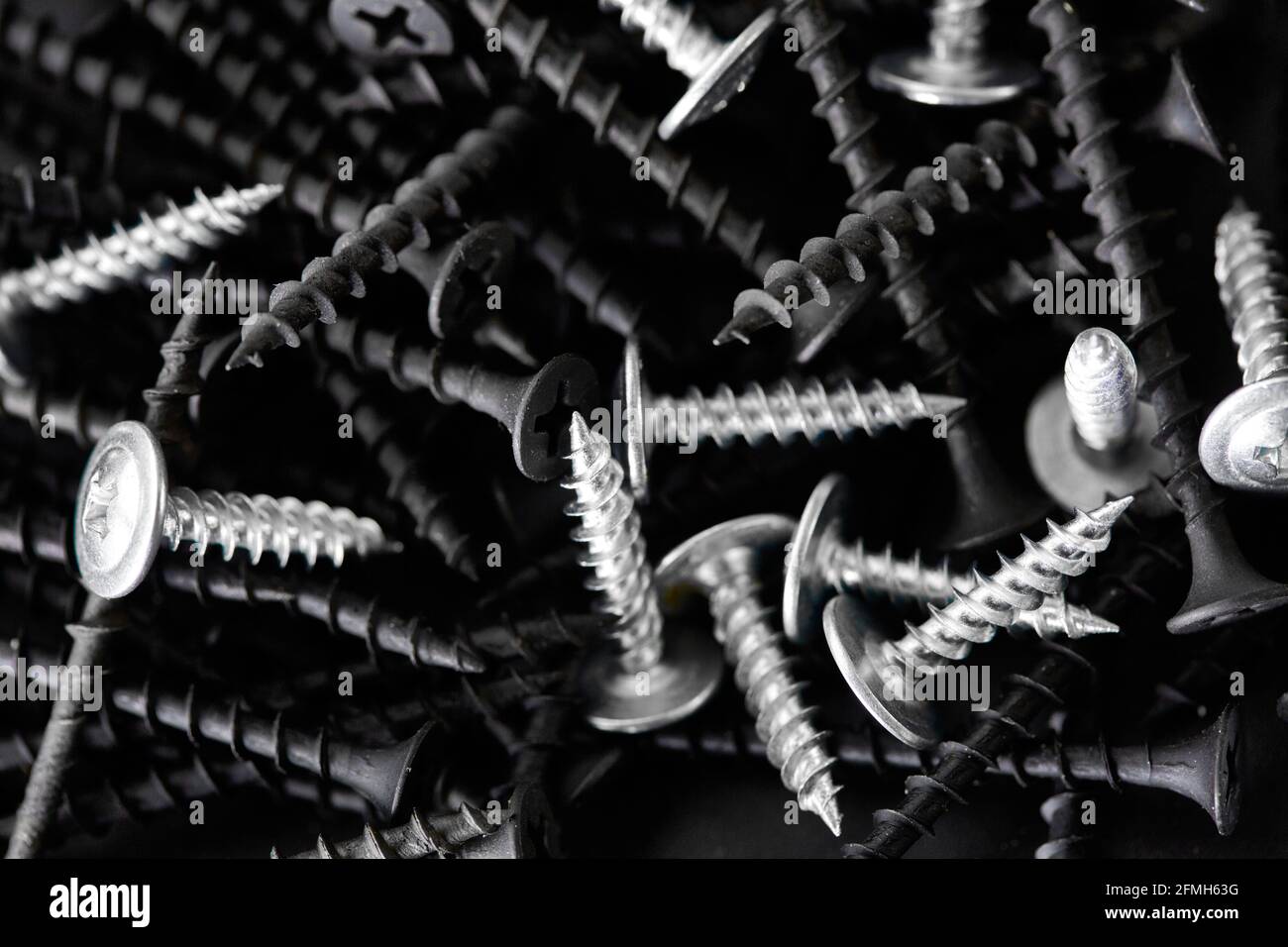 Stack of self-tapping screws, grey background Stock Photo - Alamy