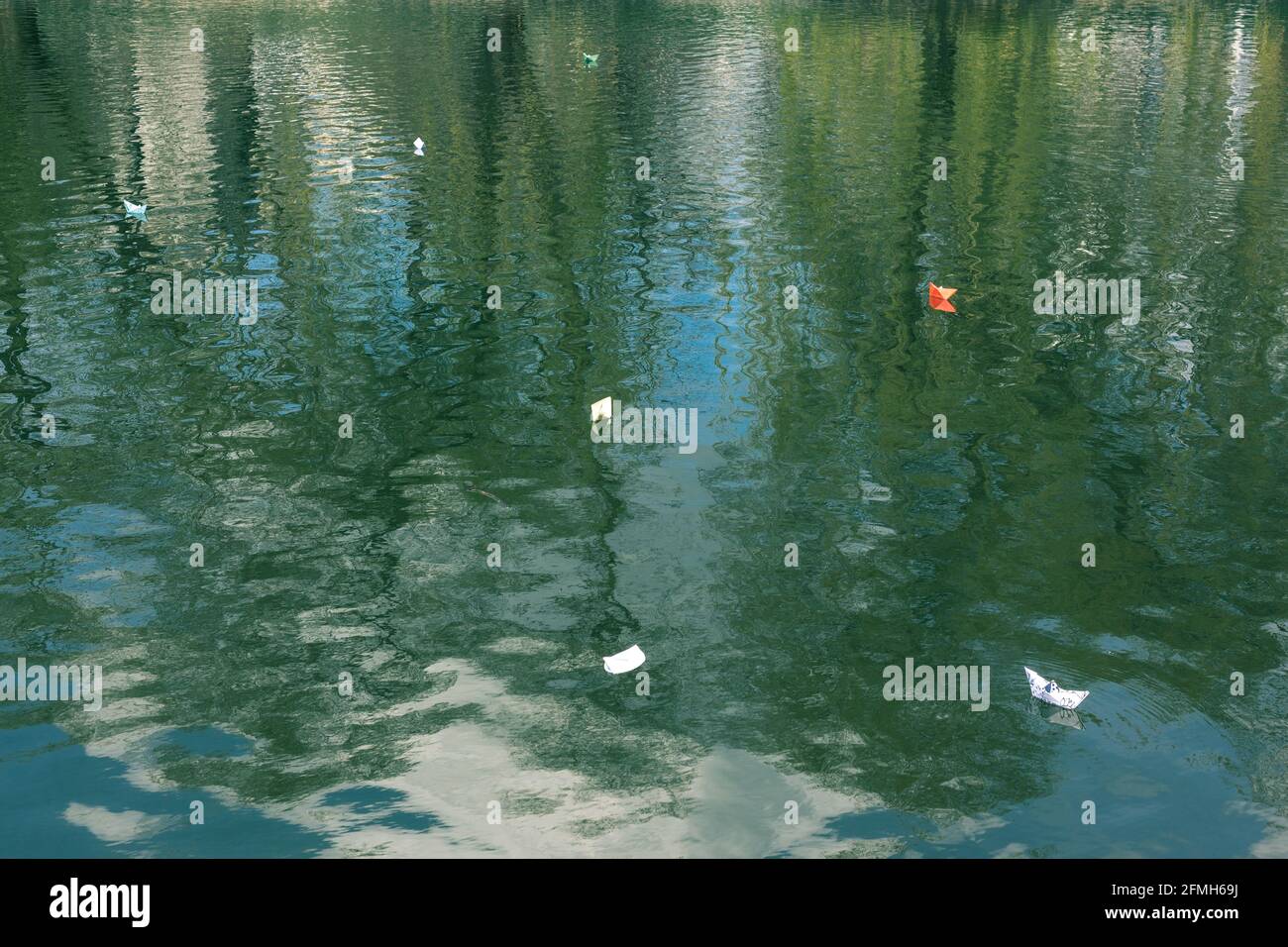 Many paper boats float on the water. Origami Stock Photo - Alamy