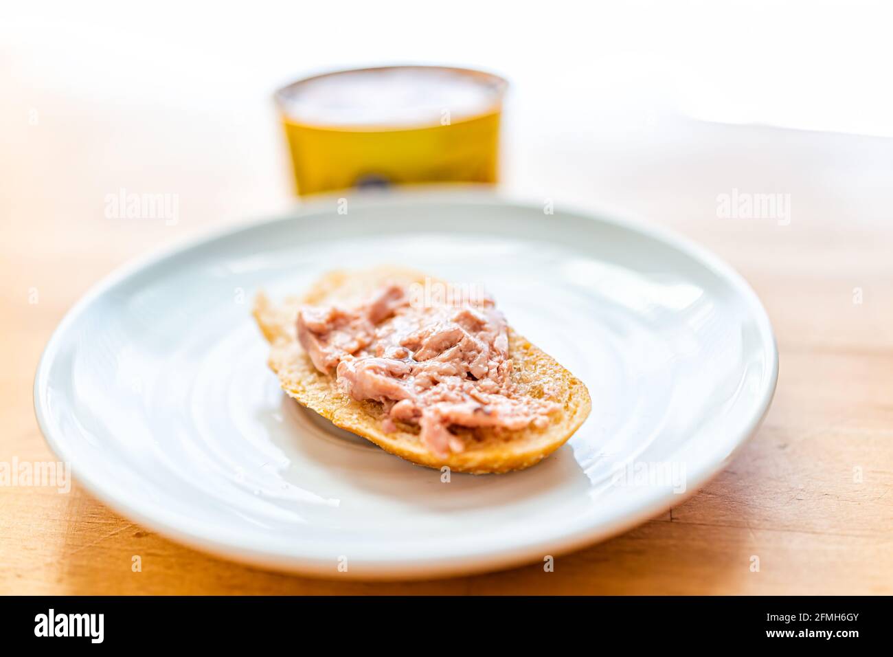 Canned cod liver in oil closeup macro of spread fish on toast bread