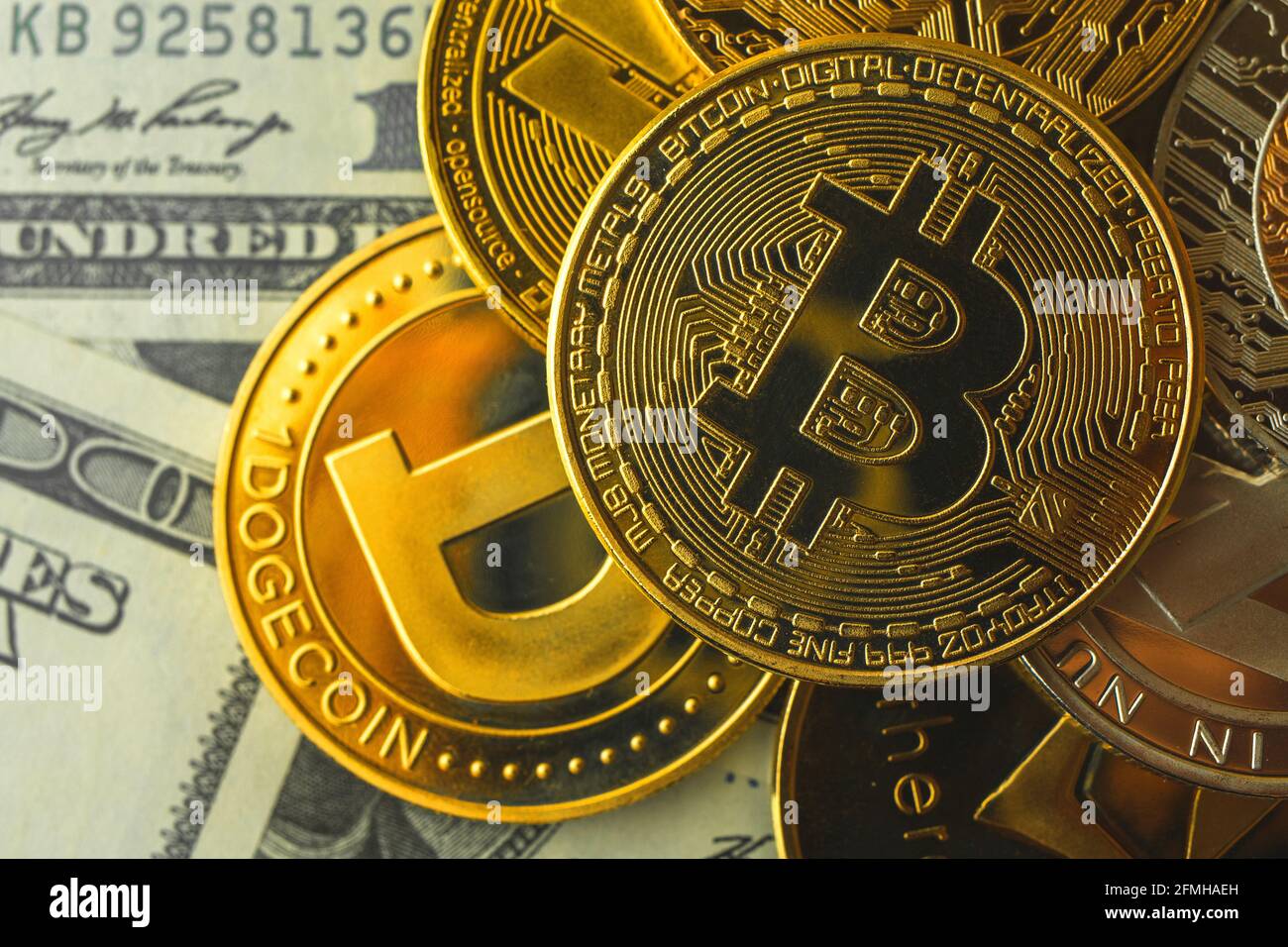 Bitcoin coin the most expensive crypto currency, bitcoin on the top,  dollars background photo Stock Photo - Alamy