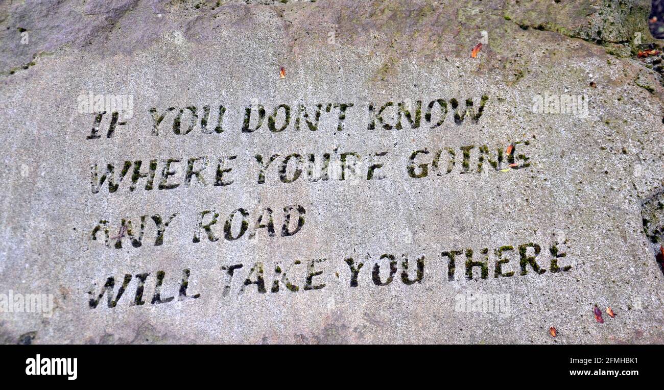 'If you don't know where you're going any road will take you there' message in a stone at Healey Dell nature reserve, United Kingdom Stock Photo
