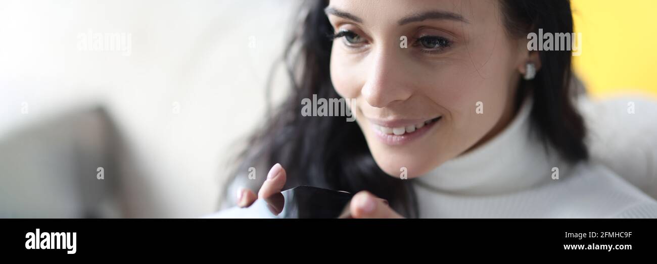 Woman holding mobile phone in hands and dialing voice message Stock Photo