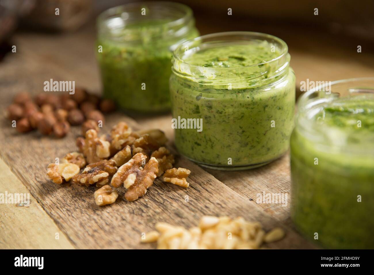 Examples of wild garlic pesto that has been made with different nuts. Left-right-Hazelnut and wild garlic pesto, walnut and wild garlic pesto and pine Stock Photo