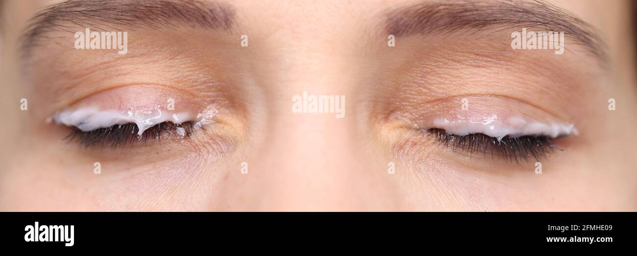 Moisturizer applied eyelid of female client beauty studio Stock Photo