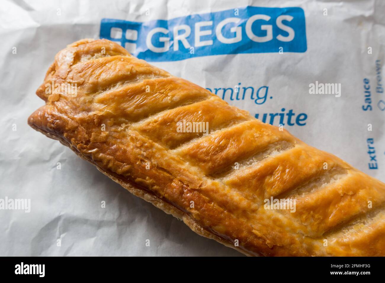 Sausage roll sausage meat wrapped in layers of crisp by Greggs bake store  Stock Photo - Alamy