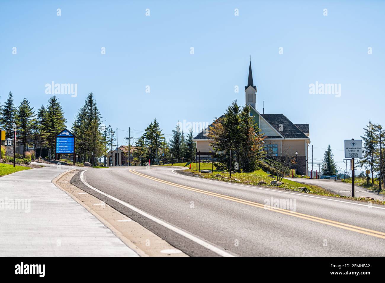 Snowshoe, USA - October 6, 2020: St Bernard chapel wooden church with view on main street sidewalk in small ski resort town village in West Virginia Stock Photo