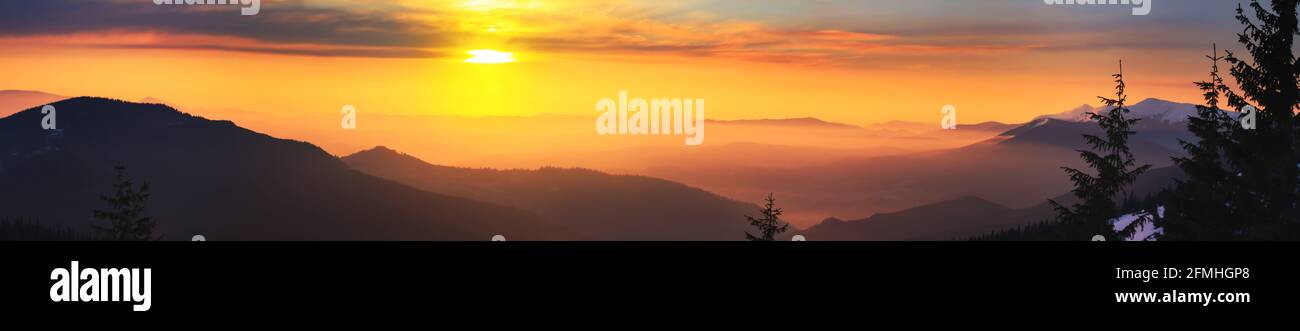 Winter landscape at sunrise, panorama, banner - view of the mountain range covered with forests, Carpathian mountains in Ukraine Stock Photo