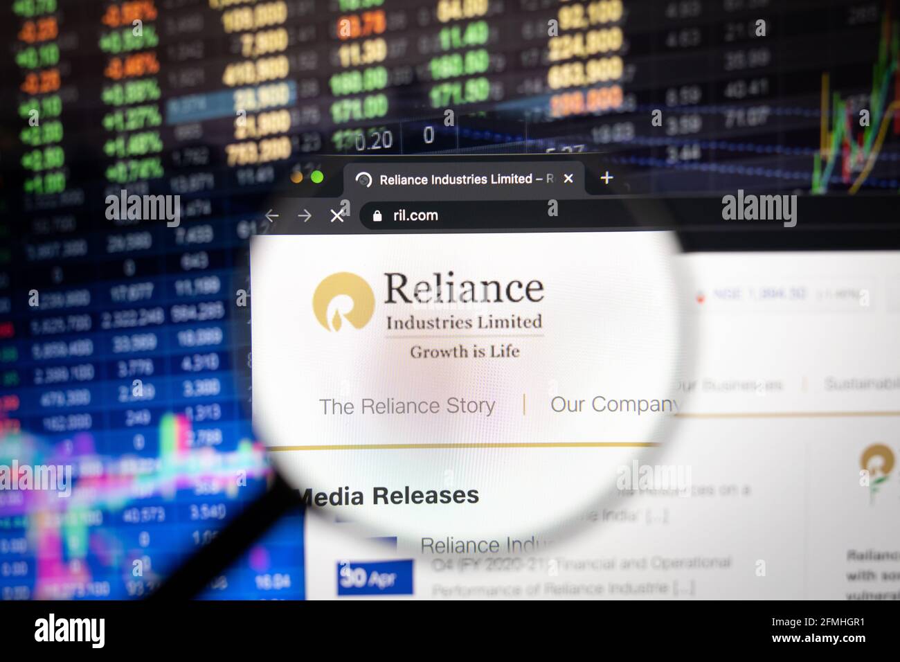 Reliance Industries Limited company logo on a website with blurry stock market developments in the background, seen on a computer screen Stock Photo