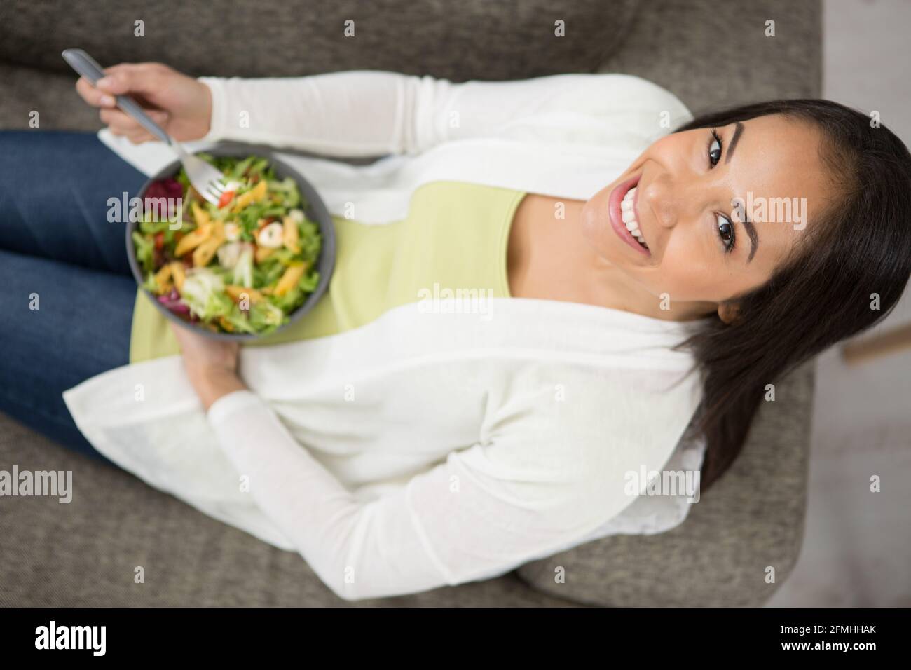young woman relaxing on the couch at home Stock Photo - Alamy