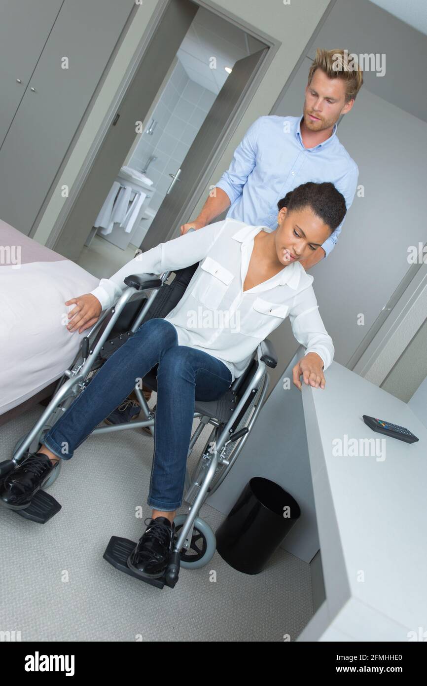 careful young male physiotherapist with disabled patient Stock Photo