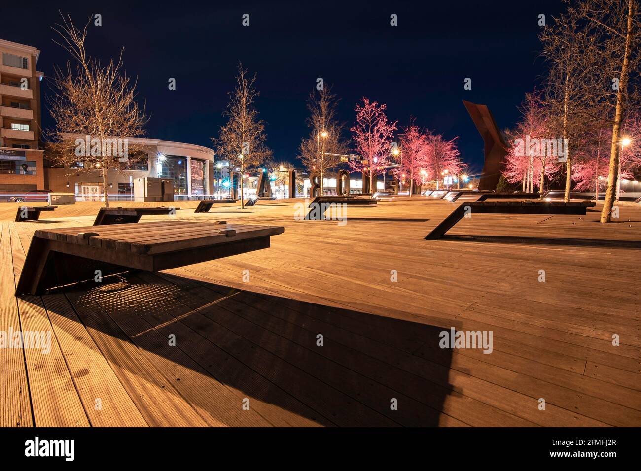 Calgary Alberta Canada, May 01 2021: Modern park benches in a public gathering area along Memorial Drive in a downtown Canadian city at night. Stock Photo