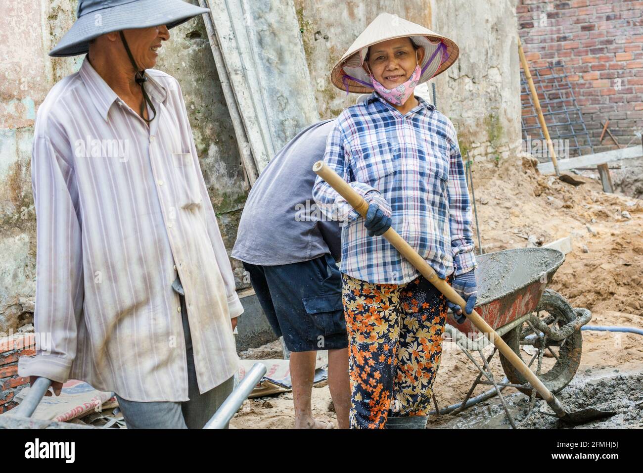 Portrait of female Vietnamese manual labourers working on building site