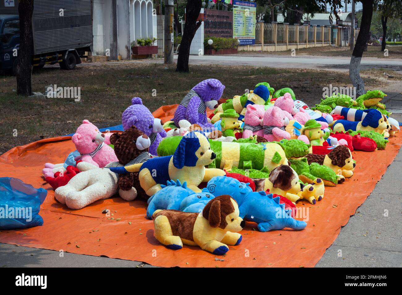 Children's cuddly animals for sale on sidewalk, Hoi An, Vietnam Stock Photo