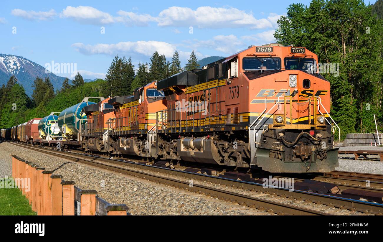 Skykomish, WA, USA - May 02, 2016; BNSF locomotives head a freight train including Boeing 737 aircraft fuselages destined for the Seattle area Stock Photo