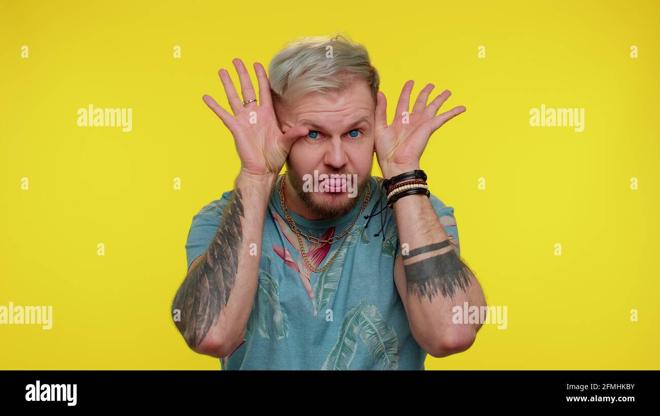 Funny tourist man making playful silly facial expressions, grimacing ...