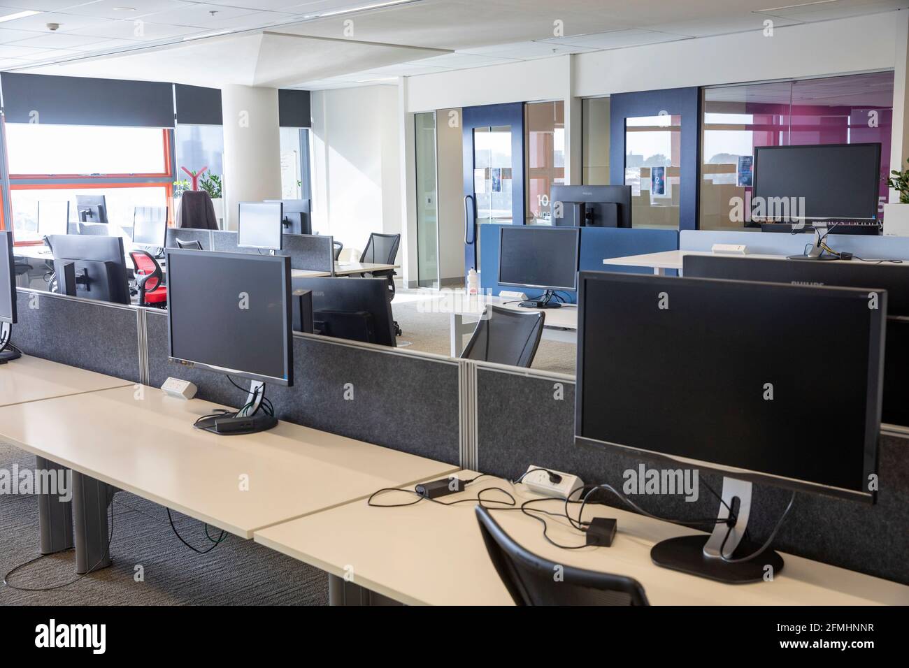Sydney office building interior with empty desks and offices due to covid 19 virus pandemic requiring people and staff to work from home,Sydney Stock Photo