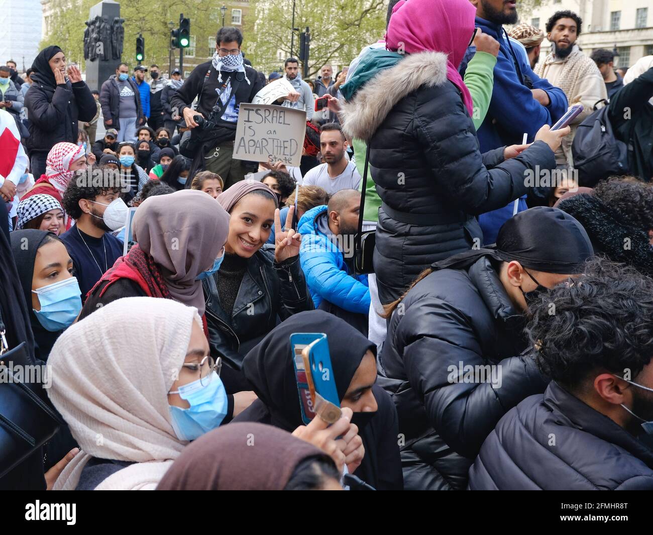 Protesters sit down and block Whitehall during a demonstration against planned and forced evictions of Palestinian families in Jerusalem Stock Photo