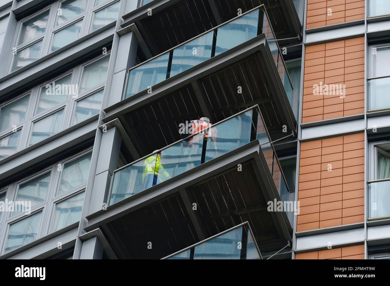 The fire service conduct safety checks after a major fire broke out at New Providence Wharf, a 19 storey high residential block in Blackwall. Stock Photo