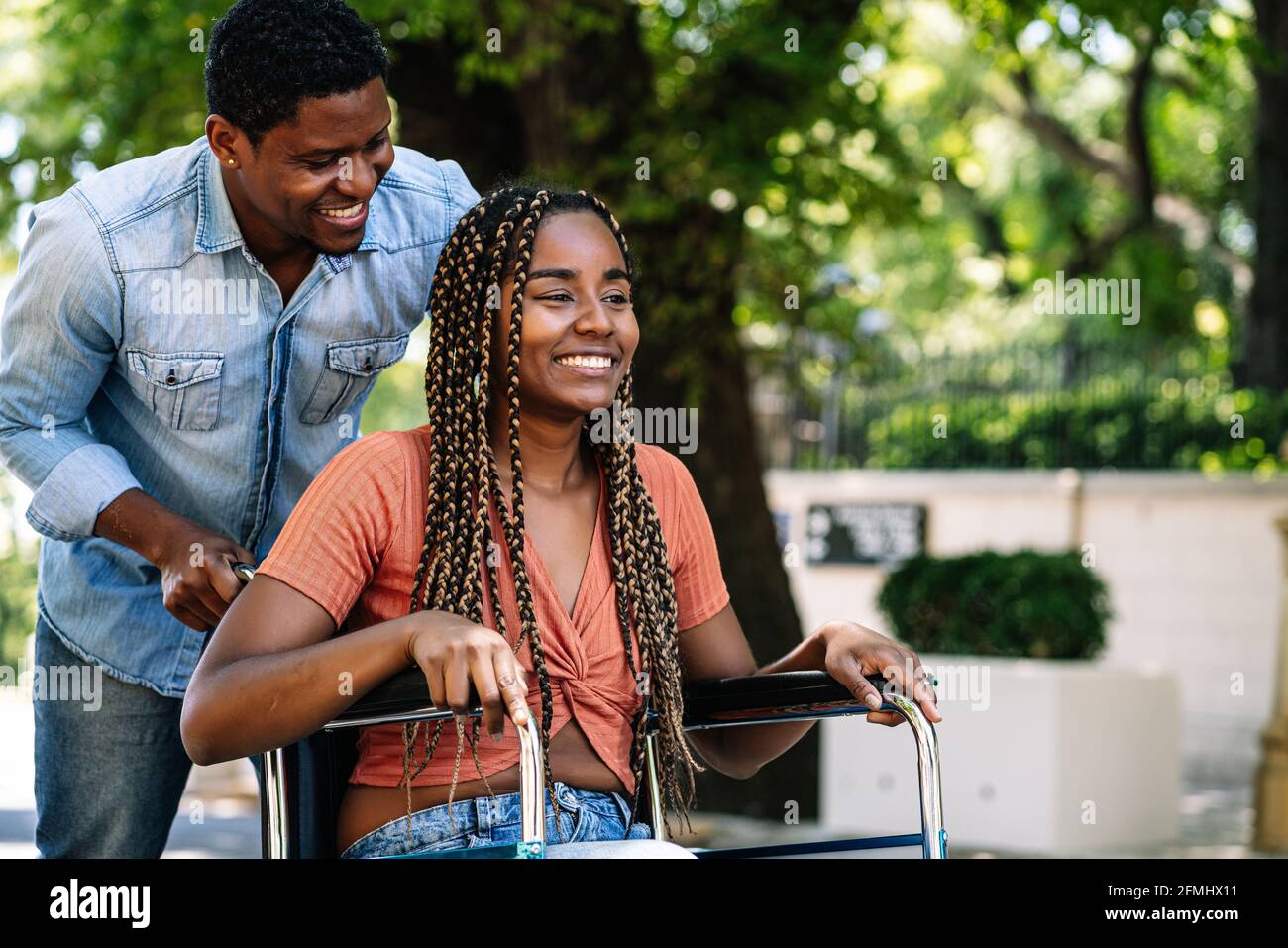 Woman in a wheelchair enjoying a walk with her boyfriend Stock Photo ...