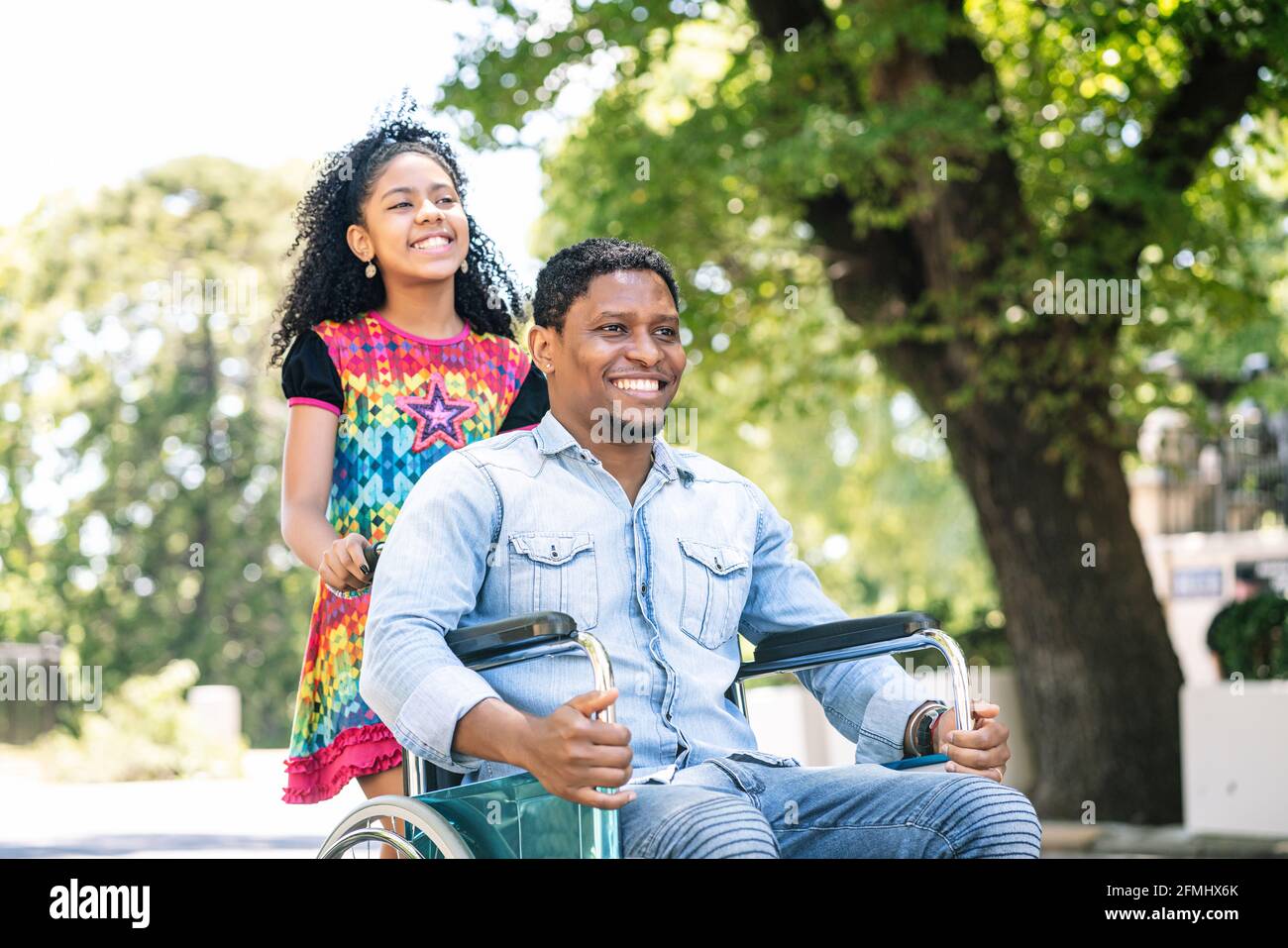 Man in a wheelchair enjoying a walk with his daughter Stock Photo - Alamy