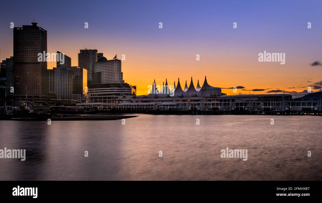 Sunset over the Harbor and the Sails of Canada Place, the Cruise Ship Terminal and Convention Center on the Waterfront of Vancouver, British Columbia, Stock Photo